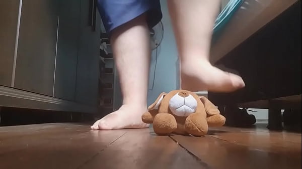 Giant feet crushing a teddy bear