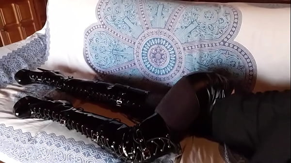 Total black with fishnets pantyhose and boots over the knee 