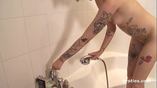 Tattooed babe showers with butt plug in her hole