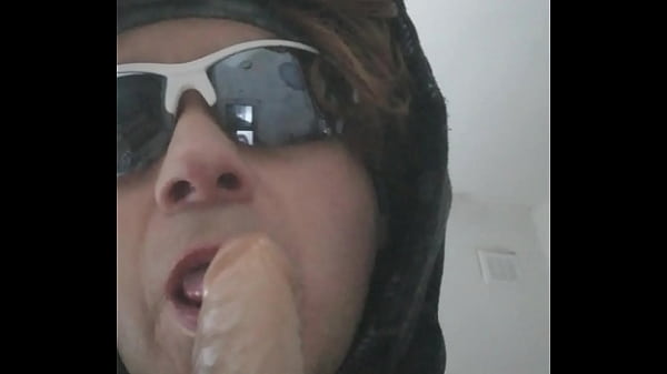 Gagging on a rubber cock, makeup and wig 