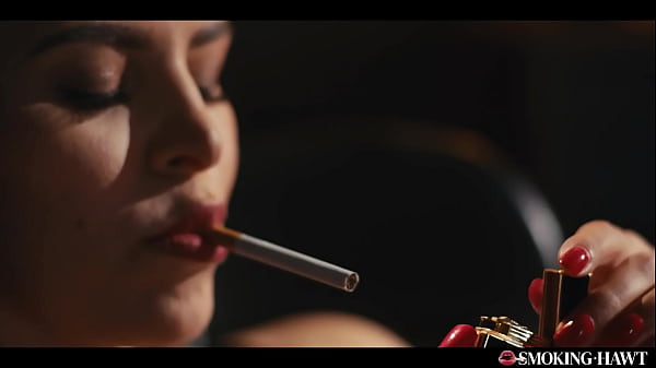 Hot brunette with red lipstick nails and sexy lingerie touching herself while smoking cigarette