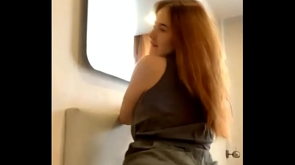 Young Russian redheaded bitch moves sexually in front of the camera