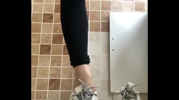 Japanese girl takes off her sneakers.