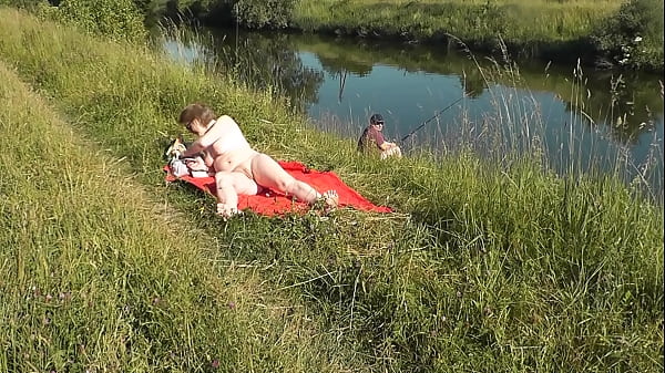 Play MP4 - MILF sexy Frina on river bank undressed and sunbathes naked&period; Random man fisherman watching for her&comma; and in the end decided to join naked woman&period; Wild beach&period; Nudist beach&period; Public nudity&period; Public exposure&period; Naked in public