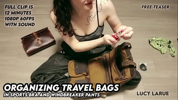 Organizing Travel Bags in Sports Bra and Windbreaker Pants 