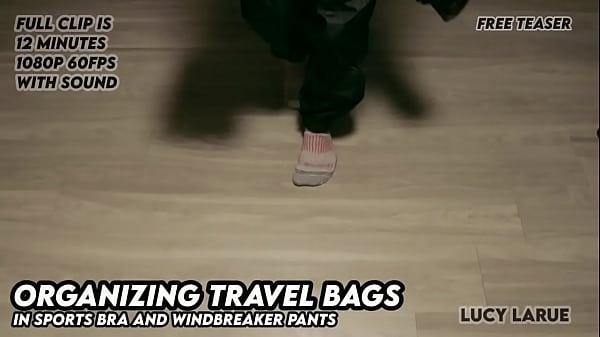 Organizing travel bags in sports bra and windbreaker pants 