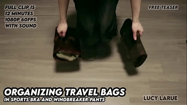 Organizing travel bags in sports bra and windbreaker pants 
