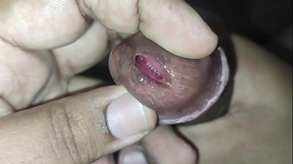 Play with tied foreskin peehole and inserting rod into dick tip