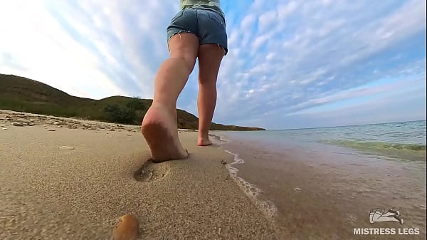 Barefoot walks over the summer seashore 