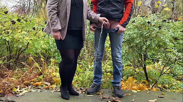 Hot milfin pantyhose and skirt_holding_guy s cock outdoors while pissing