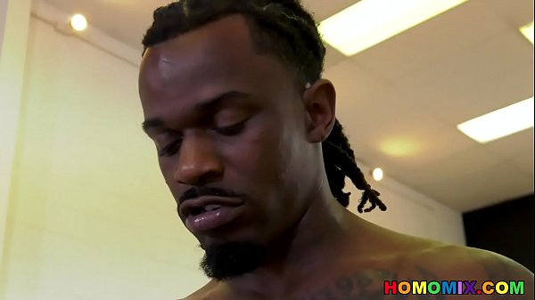 White guy growls beneath a huge cocked black bull 