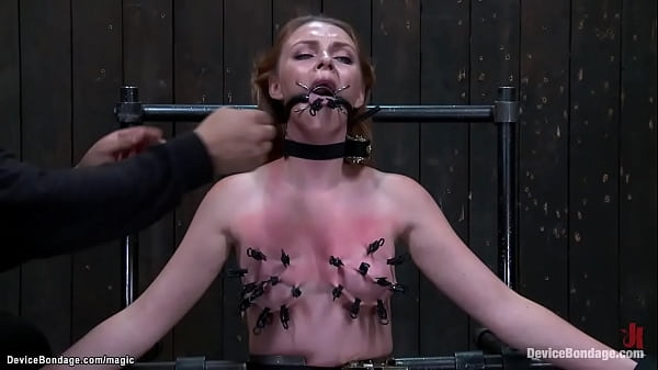 Gagged redhead slave marie mccray is straddled on sybian on knees with body bound in metal device gets tongue and skin clamped by master orlando