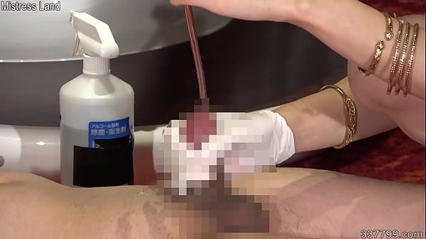 Japanese dominatrix shoves a cotton swab into a slave's urethra