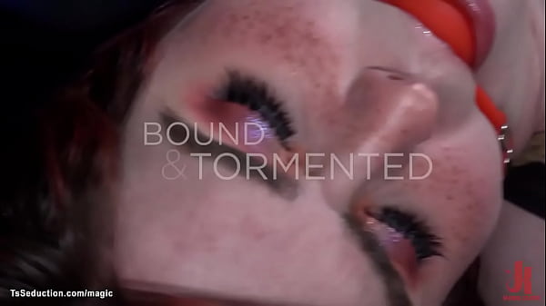 Hot redhead shemale slave Ella Hollywood in latex kinky lingerie gets gagged and bound then gets her fists suspension from master Ruckus 