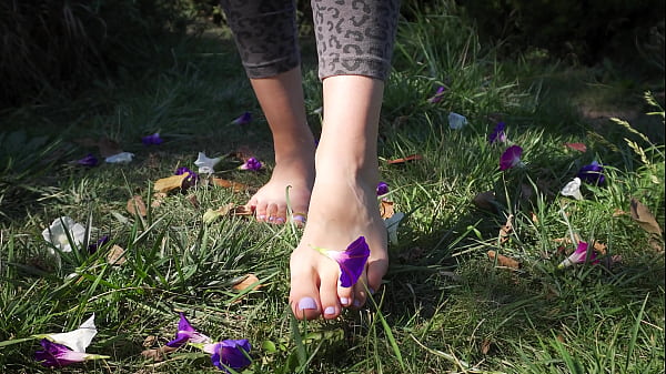 Sexy Feet With Long Toes Crushing Flowers Outdoors 4k thumbnail