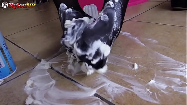 Brunette gives footjob to a white cream_tube, messy nylons