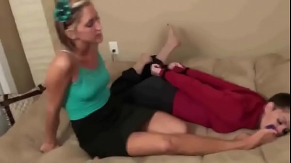 Horny Blonde licks the feet of a_pretty tied brunette