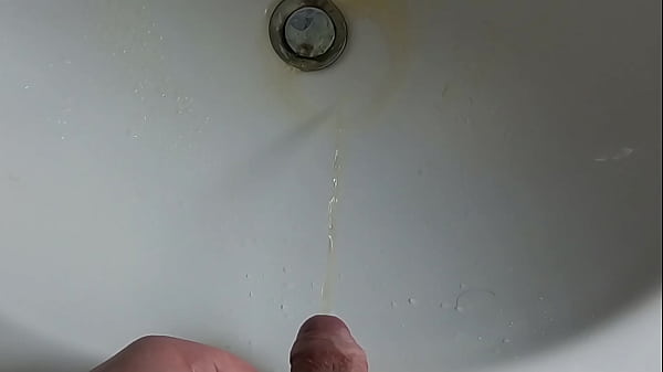 Boy is pissing in the sink and makes stinky farts 