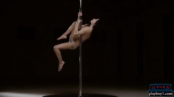 Petite MILF brunette showing off her pole dancing skills