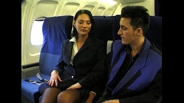 Brunette beauty_wearing_stewardess uniform gets_fucked_on a plane