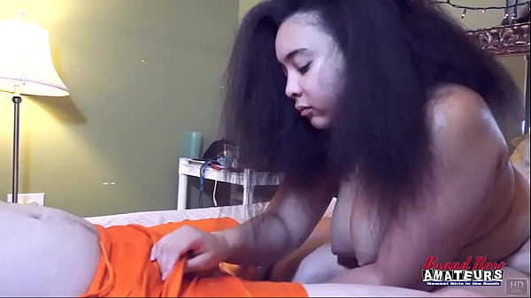 Curly haired busty brunette raquel love gives a titjob and sucks a cock