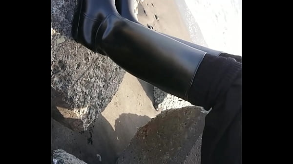 Fetish rubber boots at beach 