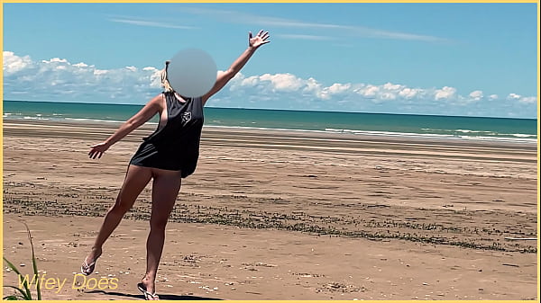 Wife plays_football nude at public_clothed_beach