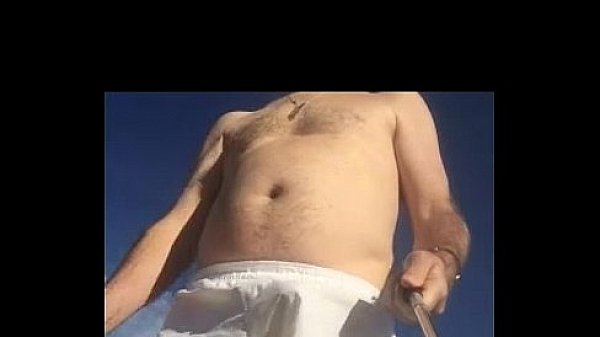 Guy in white boxers with stiffie on beach 