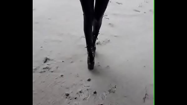 Walking on the snow with leather catsuit and ankle Platform boots. You can see my long legs and beautiful ass 