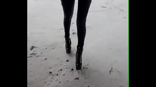 Walking on the snow with leather catsuit and ankle Platform boots. You can see my long legs and beautiful ass
