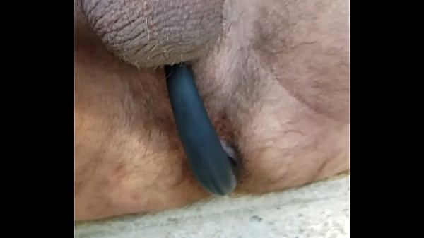 Sitting on front steps at home, flashing the world and showing one of my butt plug/ cock rings that I love to wear.