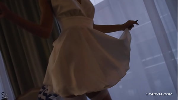 Stasyq white dressed angel holy stripping next to the christmas tree