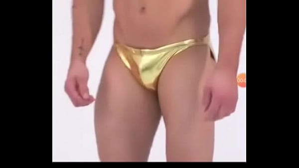 Guy in metallic golden bikini