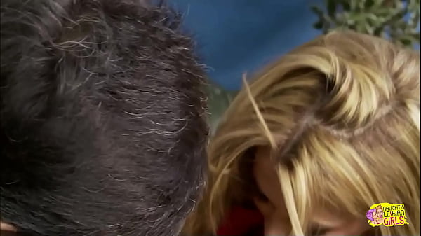 A voluptuous woman enjoys stroking a man's large phallus on the desk 