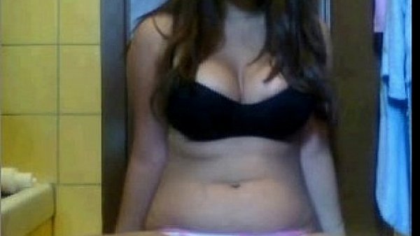 Brunette teen shows her tits and puts a finger in her pussy 