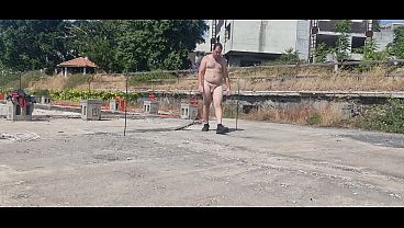 A boy completely naked in an abandoned courtyard
