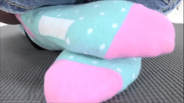 Girl with her hands tied and tickling her soles