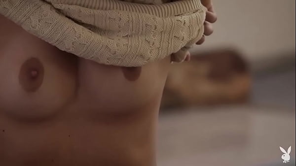 FULL SCENE on PlayGirlPlus - Kate Jones in Warm Radiance - Cuddled up by the fire, she&rsquo;s dressed in pale pink panties and a sweater atop a pile of cozy blankets 