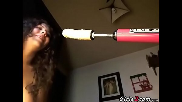 Brunette masturbates with a vibrator and a dildo machine