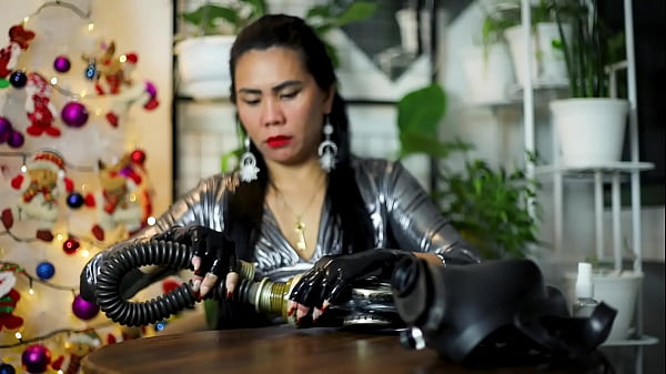 Asian dominatrix wearing rubber latex gloves
