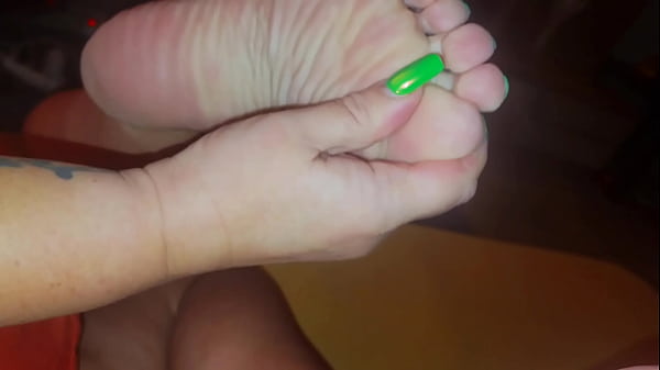 The stepmother allowed the stepson to watch as she lubricates her feet with cream 