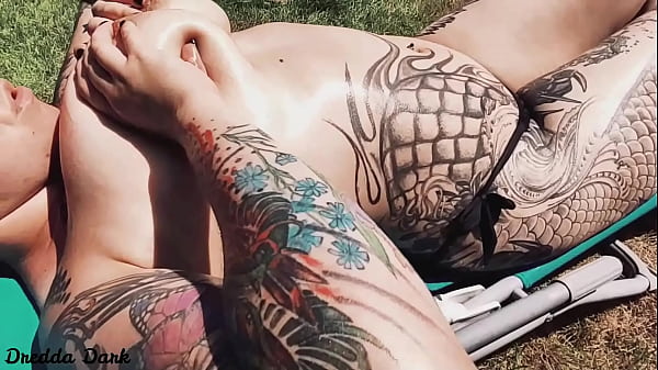 Play MP4 - Tattooed horny brunette with big boobs sunbathing in the yard and rubbing sunscreen on her tits