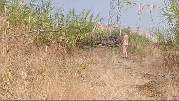 A boy completely naked in the woods