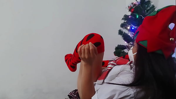 Stepmother welcomes christmas in a very sexy way she is under the christmas tree and masturbates with a dildo with christmas lights