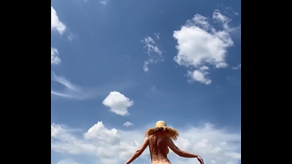 Sexy stepmother walks naked in the field 