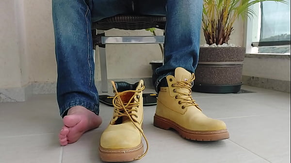 PUTTING ON THE YELLOW WORK BOOT - SLUM01