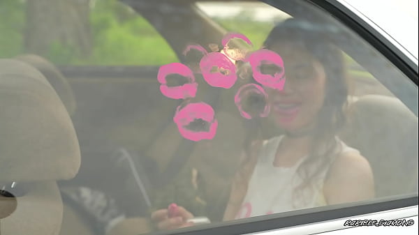 Messy pink lipgloss marks on the car window