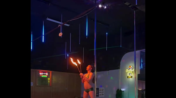 Destiny mae dancing and playing with fire on stage at the strip club