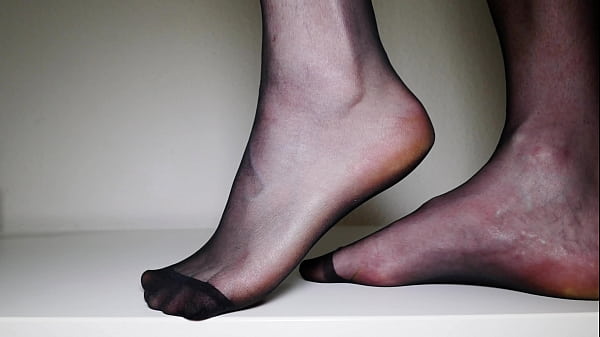 Foot play in black nylon stockings 