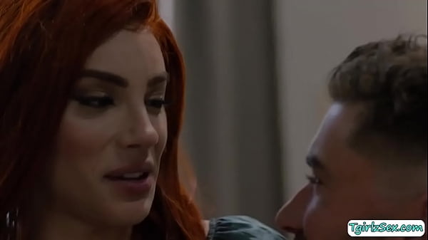 Long haried brunette shemale Ariel Demure sits with hunk Chris Damned kissing then grabs her big cock mount it up her cock hungry mouth. 